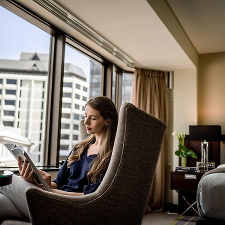 Отель Intercontinental Wellington By Ihg Экстерьер фото A guest using a tablet in a room at the hotel